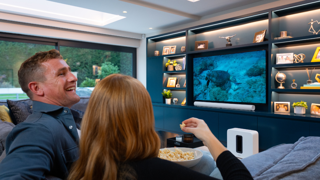 Couple Watching TV Eating Popcorn